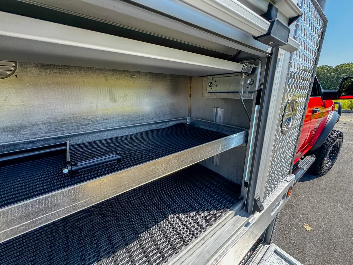 Open pump-service compartment on right side with cylinder and plumbing.